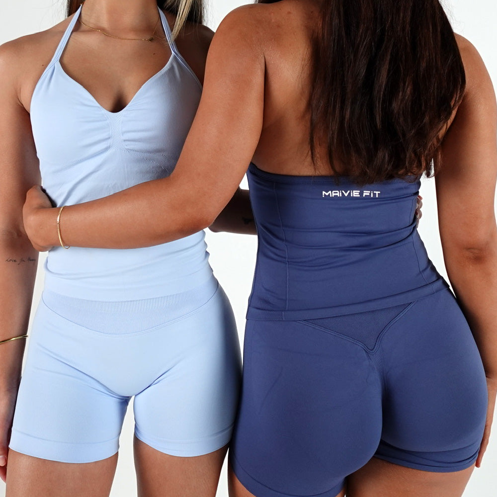 wearing mavi blue and denim athletic outfits with 'MAIVE FIT' branding.