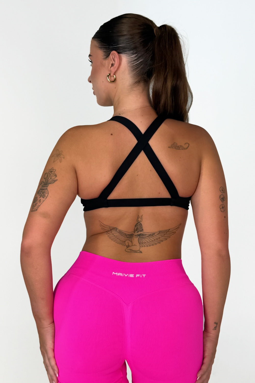 Maivie Fit Twist Crop Back View in Deep Black paired wth Hot Pink Shorts