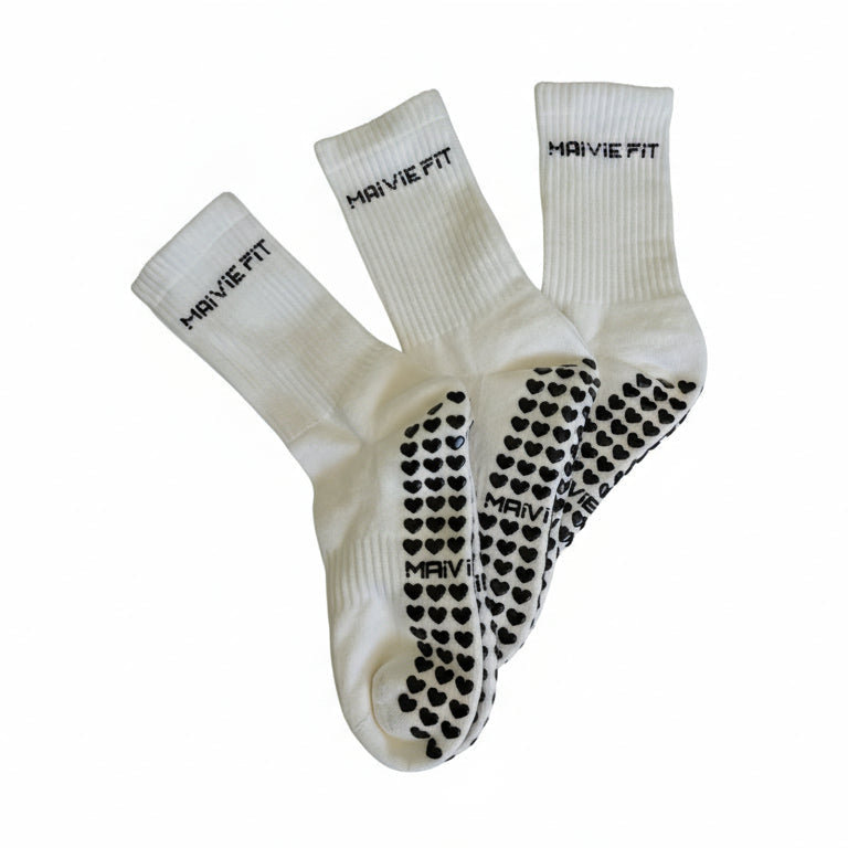 Pair of white socks with black patterns on a white background